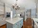 Stylish kitchen with white cabinets, stainless steel appliances, and a large center island at 5308 Sunningdale Dr, Charlotte, NC 28277
