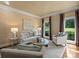 Bright living room boasts decorative wallpaper, neutral furniture, and view of landscaped outdoors at 5308 Sunningdale Dr, Charlotte, NC 28277