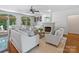 Sunlit living room features a fireplace, ceiling fan, and comfortable seating arrangement at 5308 Sunningdale Dr, Charlotte, NC 28277