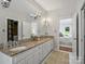 Well-lit main bathroom features granite countertops, double sinks, and access to a walk-in closet at 5308 Sunningdale Dr, Charlotte, NC 28277