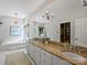 Large main bathroom features double sinks, granite countertops, a soaking tub, and a chandelier at 5308 Sunningdale Dr, Charlotte, NC 28277