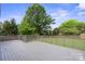 Staged open back deck overlooking a grassy yard and mature trees at 554 Isle Of Pines Rd, Mooresville, NC 28117