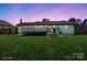 Spacious backyard featuring a lovely deck, perfect for outdoor entertaining at dusk at 554 Isle Of Pines Rd, Mooresville, NC 28117