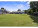 Large backyard with grassy lawn, privacy fence, and mature trees at 554 Isle Of Pines Rd, Mooresville, NC 28117