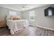 Bright bedroom with modern ceiling fan, hardwood floors, and plentiful natural light at 554 Isle Of Pines Rd, Mooresville, NC 28117