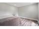 Bedroom with wood floors and neutral walls, virtually staged with bed and side table at 554 Isle Of Pines Rd, Mooresville, NC 28117