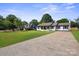 Well-maintained single-story home with a spacious driveway and lush greenery at 554 Isle Of Pines Rd, Mooresville, NC 28117