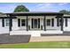 Inviting front porch with decorative columns and manicured landscaping at 554 Isle Of Pines Rd, Mooresville, NC 28117