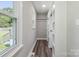 Hallway with hardwood floors, closet, and natural light from windows at 554 Isle Of Pines Rd, Mooresville, NC 28117