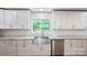 Kitchen features stainless appliances, granite countertops, and farmhouse sink at 554 Isle Of Pines Rd, Mooresville, NC 28117