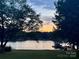 Beautiful waterfront view with dock and glistening water in the evening at 554 Isle Of Pines Rd, Mooresville, NC 28117