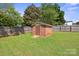 Brick shed in fenced backyard offers extra storage space at 554 Isle Of Pines Rd, Mooresville, NC 28117