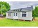 Charming backyard shed with white trim, a black metal roof, and a well-maintained lawn at 622 University Dr, Rock Hill, SC 29730