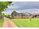 Brick home featuring a long driveway, well-kept lawn, and classic architectural design at 622 University Dr, Rock Hill, SC 29730