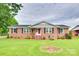 Charming brick home with a well-manicured lawn, inviting front porch, and beautiful landscaping at 622 University Dr, Rock Hill, SC 29730