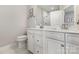 Bathroom featuring a double vanity with marble countertop, modern fixtures, and a framed mirror at 625 Uwharrie River Rd, Charlotte, NC 28211