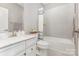 Well-lit bathroom with a vanity, toilet, and a tiled shower-tub combination at 625 Uwharrie River Rd, Charlotte, NC 28211