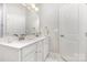 Bright bathroom features double sinks with white cabinetry, a large mirror and neutral paint at 625 Uwharrie River Rd, Charlotte, NC 28211