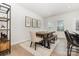 Dining room featuring neutral walls, wood table and floors, natural light, and modern shelving at 625 Uwharrie River Rd, Charlotte, NC 28211