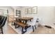 Dining room with a wooden table, bench, upholstered chairs, and modern decor at 625 Uwharrie River Rd, Charlotte, NC 28211