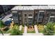 This is a lovely three-story townhome with brick and gray painted accents and manicured landscaping at 625 Uwharrie River Rd, Charlotte, NC 28211