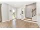 Bright and inviting foyer with hardwood floors, staircase, and a glass-paneled front door at 625 Uwharrie River Rd, Charlotte, NC 28211