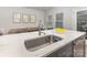 Kitchen island featuring a stainless steel sink and view of the dining area at 625 Uwharrie River Rd, Charlotte, NC 28211