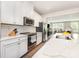 Bright, modern kitchen featuring white cabinetry, stainless steel appliances, and a marble countertop at 625 Uwharrie River Rd, Charlotte, NC 28211