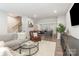 Open concept living room leading to kitchen, featuring modern decor and neutral color palette at 625 Uwharrie River Rd, Charlotte, NC 28211