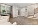 Bright living room featuring neutral walls, wood floors, staircase, and natural light from the window at 625 Uwharrie River Rd, Charlotte, NC 28211