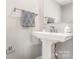 Elegant powder room with a pedestal sink, modern fixtures, and decorative towel at 625 Uwharrie River Rd, Charlotte, NC 28211