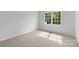 A bright bedroom featuring neutral carpeting and a window offering natural light at 6412 Sullins Rd, Charlotte, NC 28214