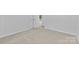 A bright bedroom featuring neutral carpeting and a white door leading to another room at 6412 Sullins Rd, Charlotte, NC 28214