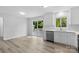 Modern kitchen with stainless steel appliances, white cabinetry, and sliding glass doors to the outdoor patio at 6412 Sullins Rd, Charlotte, NC 28214