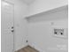 A clean and functional laundry room with hookups and a door to the exterior at 6412 Sullins Rd, Charlotte, NC 28214