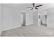A carpeted main bedroom features a ceiling fan and ensuite bath at 6412 Sullins Rd, Charlotte, NC 28214