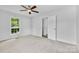 A carpeted main bedroom features a ceiling fan, a window and walk in closet at 6412 Sullins Rd, Charlotte, NC 28214