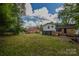 Sprawling backyard with well-maintained lawn and mature trees offering ample outdoor space at 6921 Idlewild Rd, Charlotte, NC 28212