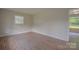 Cozy bedroom featuring fresh paint, new hardwood flooring, and lots of natural light from the windows at 6921 Idlewild Rd, Charlotte, NC 28212