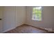 Bedroom with hardwood floors, window, and closet at 6921 Idlewild Rd, Charlotte, NC 28212
