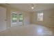 Bedroom featuring tile floors and glass panel doors to a screened in porch at 6921 Idlewild Rd, Charlotte, NC 28212