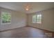 Cozy bedroom featuring fresh paint, new hardwood flooring, and lots of natural light from the windows at 6921 Idlewild Rd, Charlotte, NC 28212