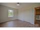 Bedroom featuring hardwood floors, closet, and a bright window at 6921 Idlewild Rd, Charlotte, NC 28212