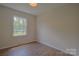Bedroom featuring hardwood floors and a bright window at 6921 Idlewild Rd, Charlotte, NC 28212