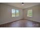 Spacious bedroom with large windows and wood-look floors at 6921 Idlewild Rd, Charlotte, NC 28212