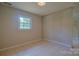 Bedroom featuring tile floors and a bright window at 6921 Idlewild Rd, Charlotte, NC 28212