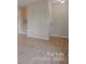 Bright living room featuring freshly painted walls, brand new hardwood flooring, and updated trim at 6921 Idlewild Rd, Charlotte, NC 28212
