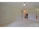 Living room featuring tile floors and staircase at 6921 Idlewild Rd, Charlotte, NC 28212