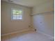 Neutral room with a bright window, shelf, and durable tile flooring at 6921 Idlewild Rd, Charlotte, NC 28212