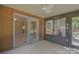 Cozy sunroom with double doors, multiple windows, and tiled floor at 6921 Idlewild Rd, Charlotte, NC 28212